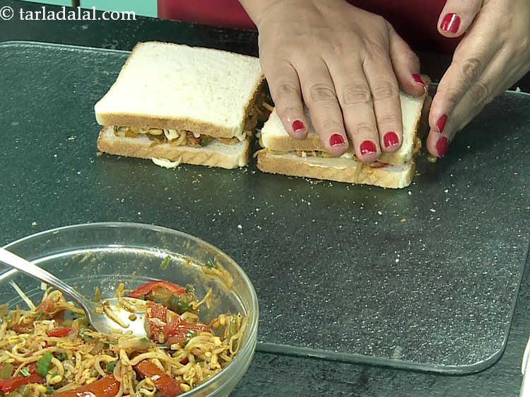 Step 28 – Sandwich them with the remaining 2 bread slices with the buttered side facing downwards.