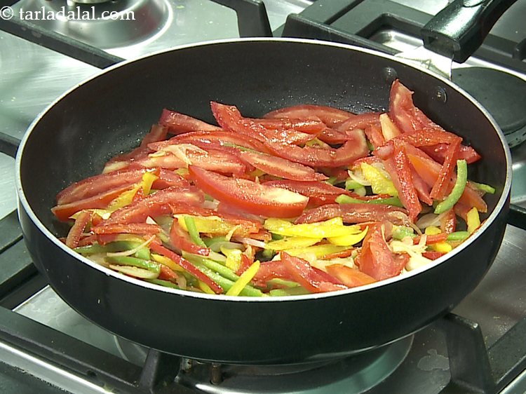 Step 9 – Add the tomatoes. These add slight juiciness to the <strong>noodle stuffing</strong>.&nbsp;