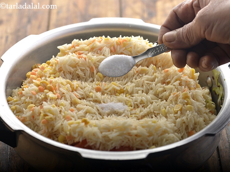 Step 23 – Add the soaked rice, dals and salt.