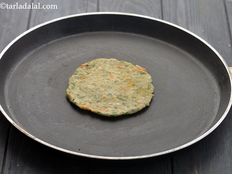 Step 14 – Heat a non-stick tava (griddle) and cook the paratha lightly on bottom side.