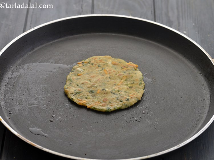 Step 15 – Flip the paratha and using &frac12; tsp of ghee, cook the&nbsp;<strong>Vegetable Parathas for Babies</strong>&nbsp;till golden …