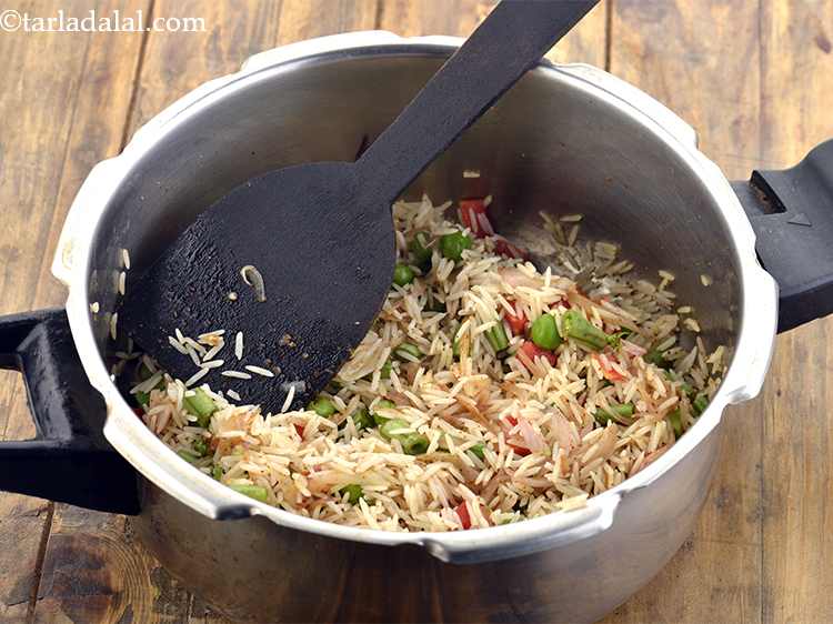 Step 11 – Add the drained rice, mix gently and cook on a medium flame for 1 minute, …