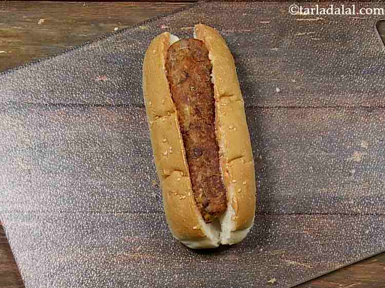 Step 28 – Slit a <strong>hot dog roll</strong> from top and lightly scoop out the centre using your …