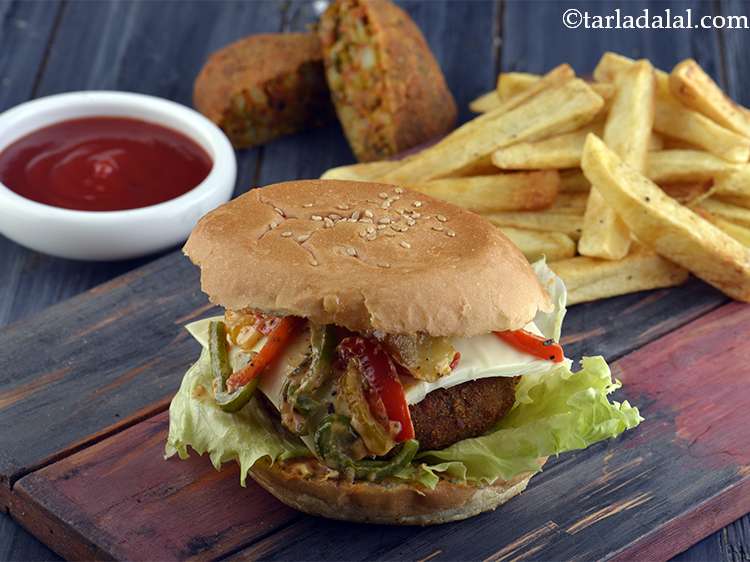 Step 49 – Serve the <strong>Veggie Burger</strong> immediately with <a href="https://www.tarladalal.com/French-Fries-(-Burgers-and-Smoothies-Recipe)-36312r">homemade French fries</a>.