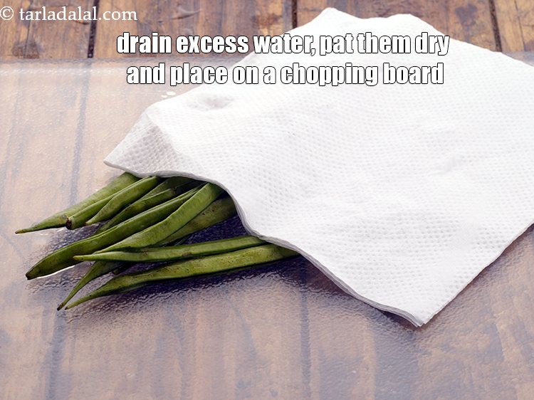 Step 5 – <meta charset="UTF-8" />Drain excess water, pat them dry and place on a chopping board. image&nbsp;https://www.tarladalal.com/gavarfali-ki-sukhi-subzi-7463r