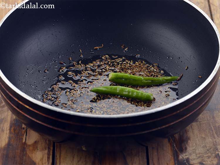 Step 3 – When the seeds crackle, add the green chillies. We have used slit green chillies but …