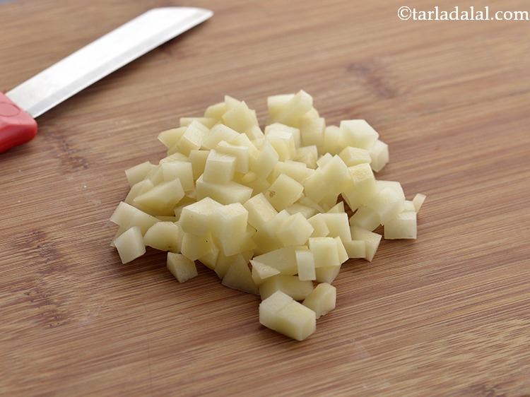 Step 23 – Add 5 tbsp&nbsp;roughly&nbsp;<a href="https://www.tarladalal.com/glossary-chopped-potatoes-787i">chopped potatoes</a>.