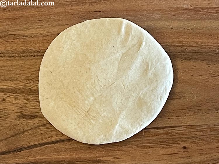 Step 12 – Take one portion of the dough and flatten it with your palm.