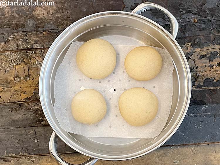 Step 17 – Place 4 round dough balls in the steamer over the cooking paper. Please keep some …