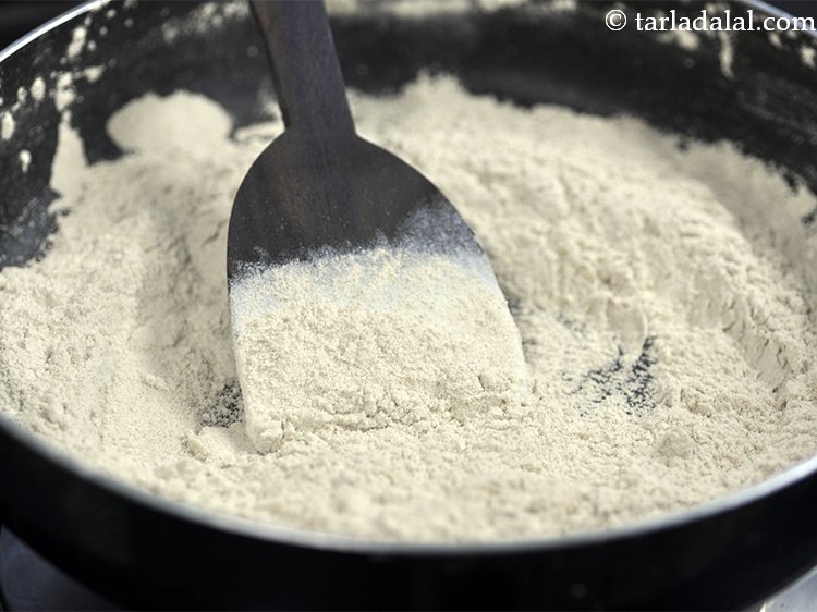 Step 17 – Keep stirring the wheat flour continuously. Ensure it does not burn by sticking to the …