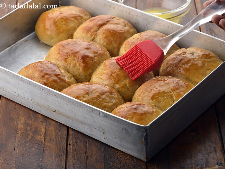 Step 35 – Once slightly cooled, de-mould it and brush the ladi pav with <a href="https://www.tarladalal.com/glossary-butter-makhan-233i">butter</a>&nbsp;and cool completely.