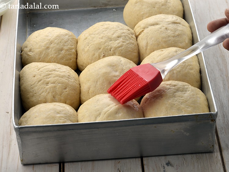 Step 32 – Brush the dough balls with the <a href="https://www.tarladalal.com/glossary-milk-514i">milk</a>&nbsp;.