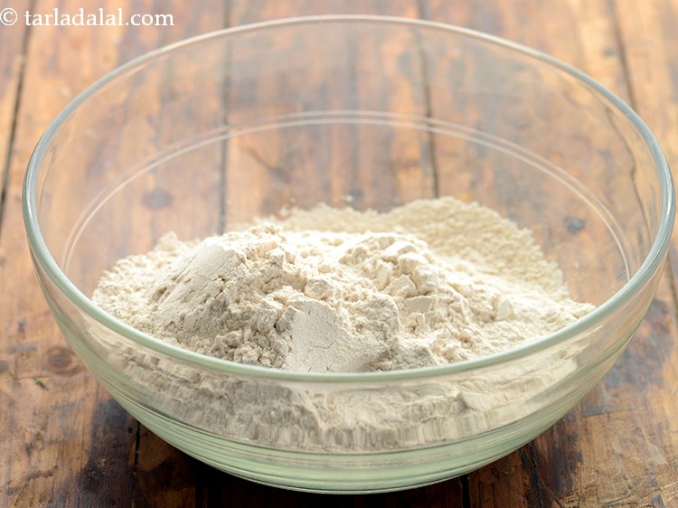 Step 16 – For preparing the dough for <strong>Homemade masala whole wheat bread rolls</strong>, in a deep bowl …