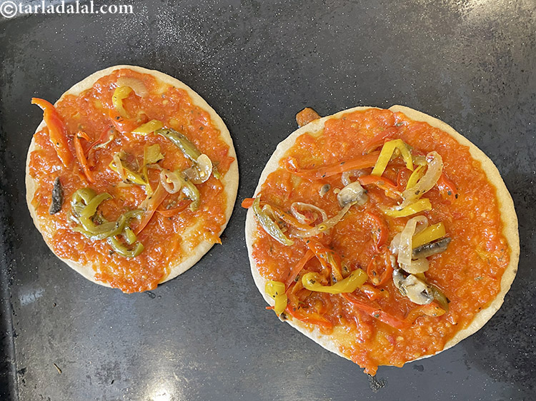 Step 33 – Top with a tablespoon of vegetables of your choice on the pizza. We used coloured …