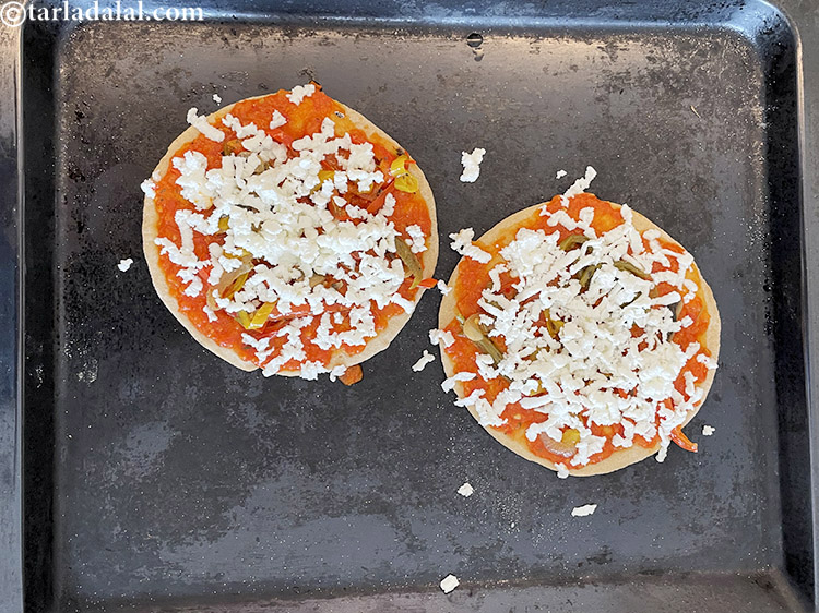 Step 34 – Top your pizza with grated paneer. We used 2 to 3 tablesppons of paneer.