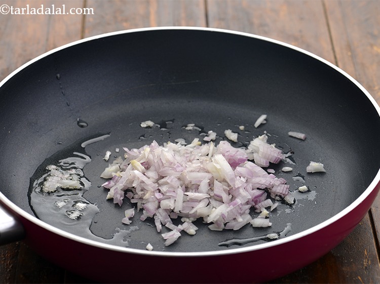 Step 27 – When the seeds crackle, add 1/2 cup&nbsp;<a href="https://www.tarladalal.com/glossary-chopped-onions-722i">chopped onions</a>.