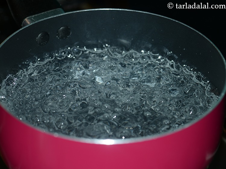 Step 2 – To boil <strong>gehun hakka noodles</strong>, boil enough water in a deep non-stick pan.