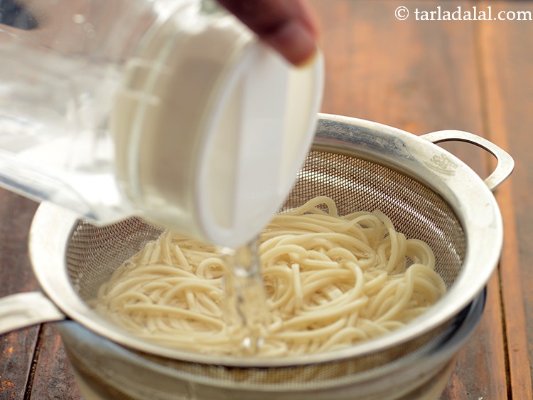 Step 7 – Pour some cold water on the noodles to stop further cooking.