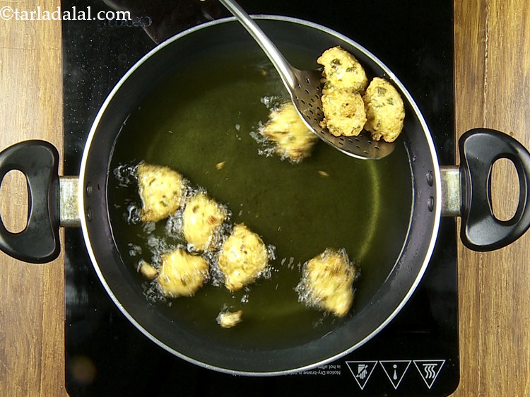 Step 26 – Deep-fry a few pakodas at a time on a medium flame till they are evenly …