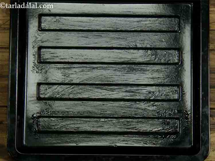 Step 12 – Grease the baking tray with 1/2 tsp of melted butter. This is to prevent the …