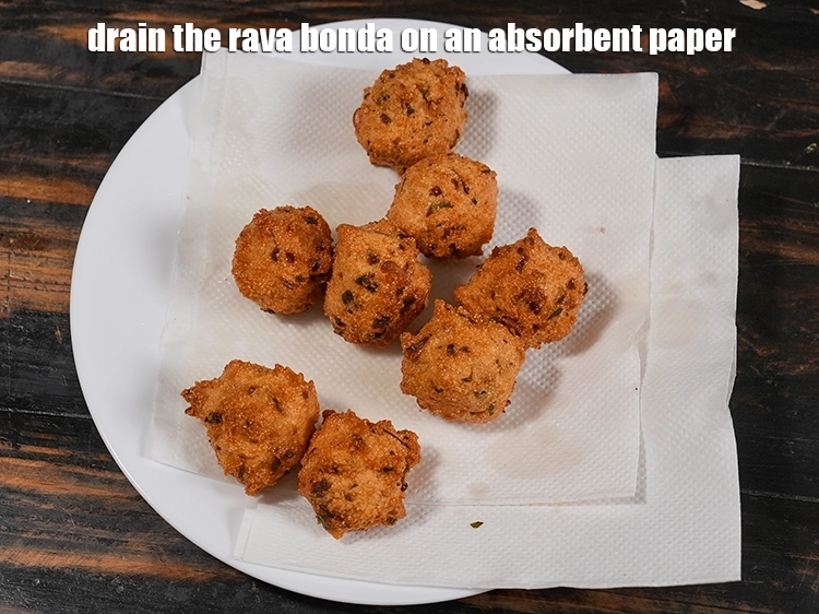 Step 23 – <p><span style="background-color:rgb(255,255,255);color:rgb(0,0,0);">Drain the </span><strong>rava bonda</strong><span style="background-color:rgb(255,255,255);color:rgb(0,0,0);"> on an absorbent paper.</span></p>