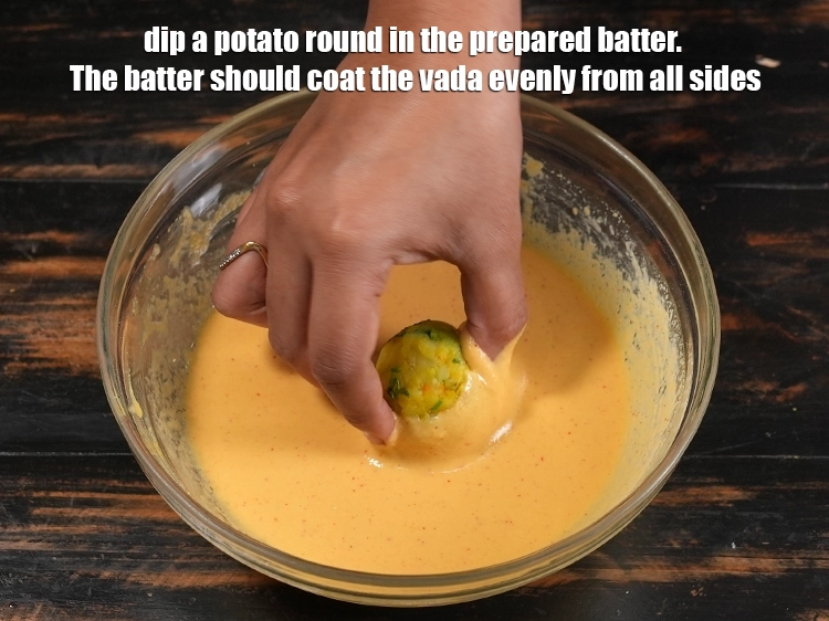 Step 42 – <p><span style="background-color:rgb(255,255,255);color:rgb(0,0,0);">Dip a potato round in the prepared batter. The batter should coat the vada …