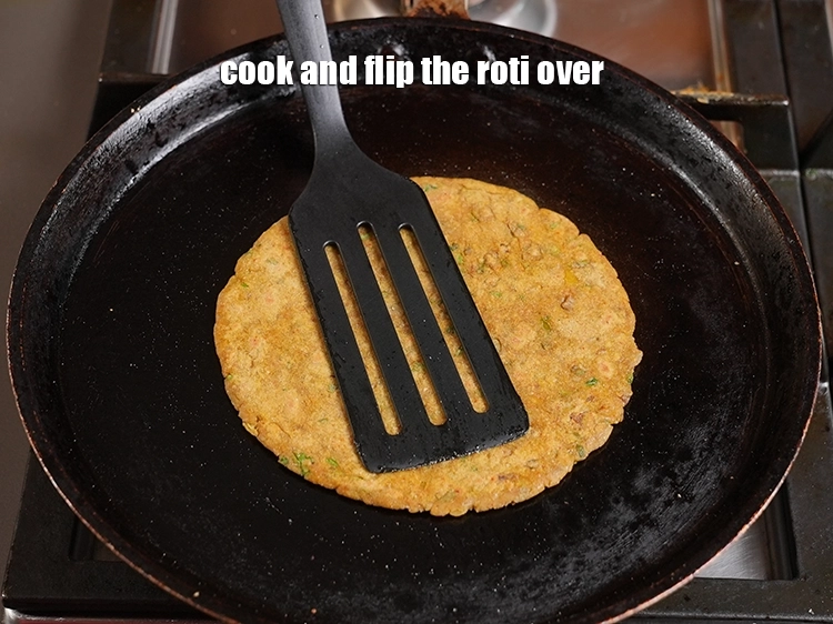 Step 18 – <p>Cook and flip the roti over.</p>