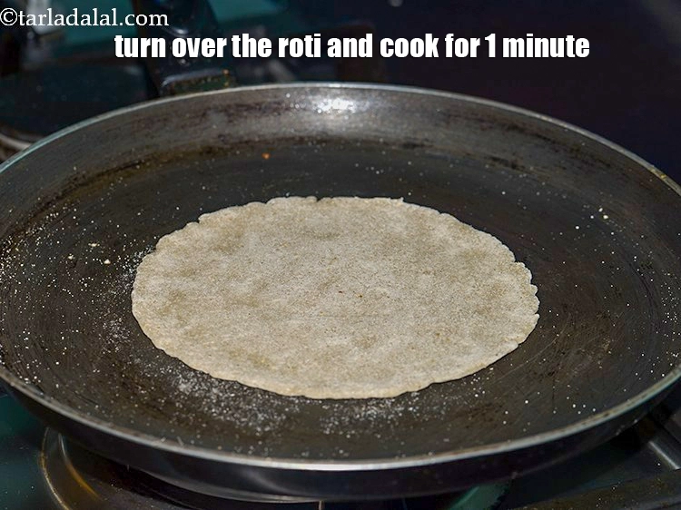 Step 16 – <p>Turn over the roti and cook for 1 minute.</p>