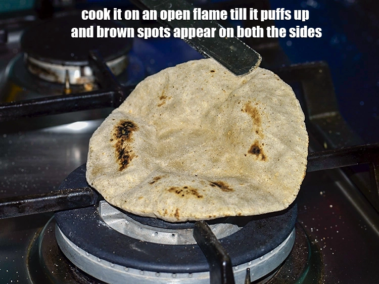 Step 17 – <p>Cook it on an open flame till it puffs up and brown spots appear on …