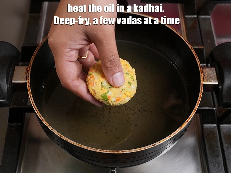 Step 22 – <p>Heat the oil in a kadhai. Deep-fry, a few vadas at a time.</p>