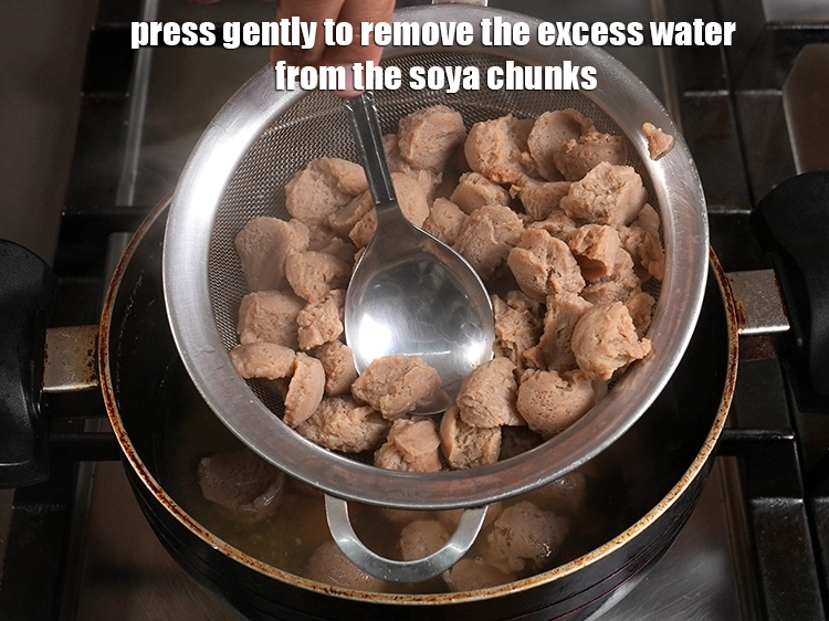 Step 13 – <p>Press gently to remove the excess water from the soya chunks. Keep aside.</p>