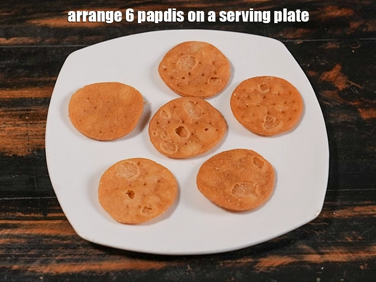 Step 4 – <p>Just before serving the Mumbai <strong>sev puri chaat recipe</strong>, arrange 6 papdis on a serving …