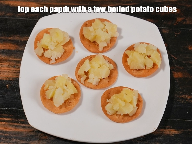 Step 5 – <p>Top each papdi with a few potato cubes. If you are Jain, top it with …