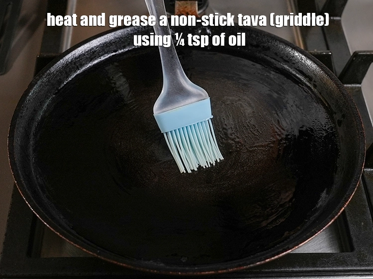Step 23 – <html><head><meta charset="UTF-8"></head><body><p>Heat and grease a non-stick tava (griddle) using ¼ tsp of oil.</p></body></html>