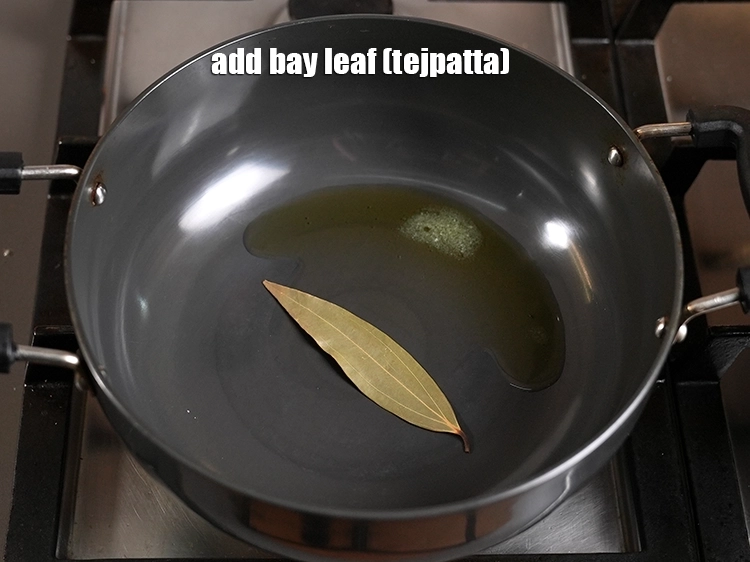 Step 22 – <p><span style="background-color:rgb(255,255,255);color:rgb(0,0,0);">Once the ghee is melted and hot, add the </span><a href="https://www.tarladalal.in/glossary-bay-leaf-tejpatta-bay-leaves-189i"><u>bay leaf (tejpatta)</u></a><u>.</u></p>