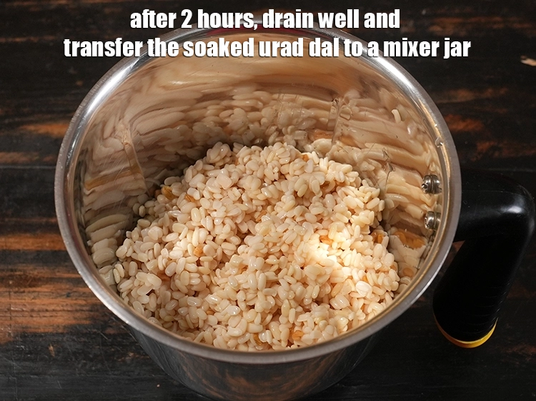 Step 5 – <p>After 2 hours, drain well and transfer the soaked urad dal to a mixer jar.</p>