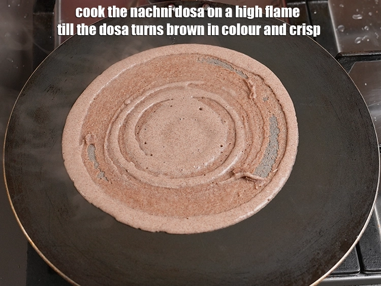 Step 21 – <p>Cook the nachni dosa on a high flame till the dosa turns brown in colour …