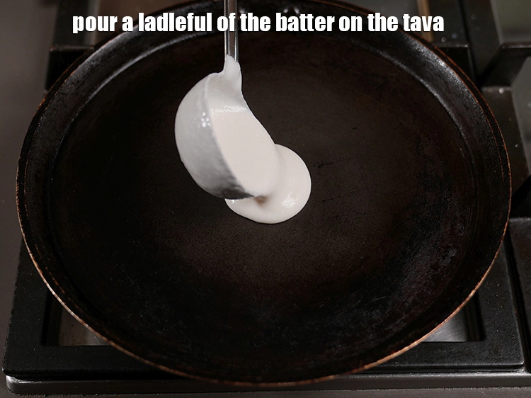 Step 37 – <p><span style="background-color:rgb(255,255,255);color:rgb(0,0,0);">Pour a ladleful of&nbsp;batter on the tava (griddle).</span></p>