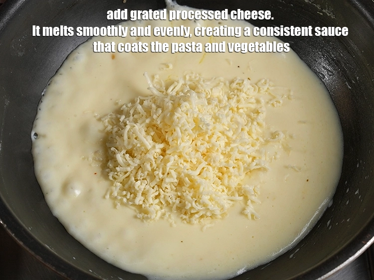 Step 20 – <p><span style="background-color:rgb(255,255,255);color:rgb(0,0,0);">Add ½ cup </span><a href="https://www.tarladalal.in/glossary-processed-cheese-315i#ing_3090"><u>grated processed cheese</u></a><span style="background-color:rgb(255,255,255);color:rgb(0,0,0);">. It melts smoothly and evenly, creating …