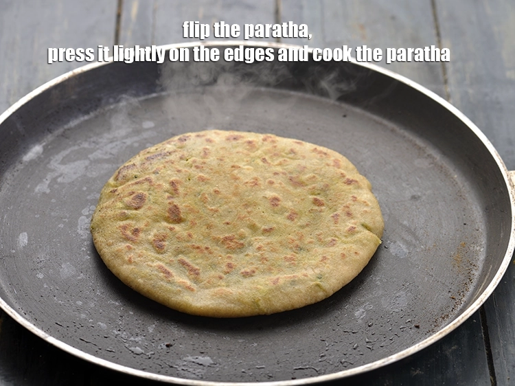 Step 27 – <p>Flip the&nbsp;<strong>Aloo Methi paratha</strong>, press it lightly on the edges and cook the paratha well …
