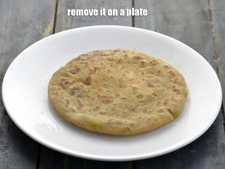 Step 28 – <p>Once the <strong>aloo methi paratha</strong> is cooked nicely on both sides, remove it on a …