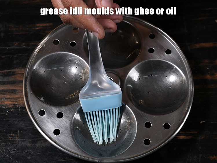 Step 36 – <p>To prepare <strong>soft and fluffy idlis at home</strong>, grease idli moulds with ghee or oil. …