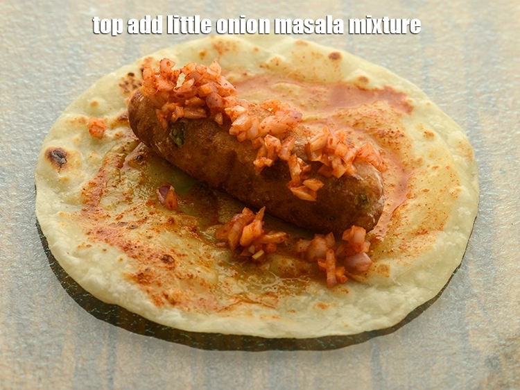 Step 42 – <p>Top <strong>aloo cheese frankie</strong> a little onion masala mixture.</p>