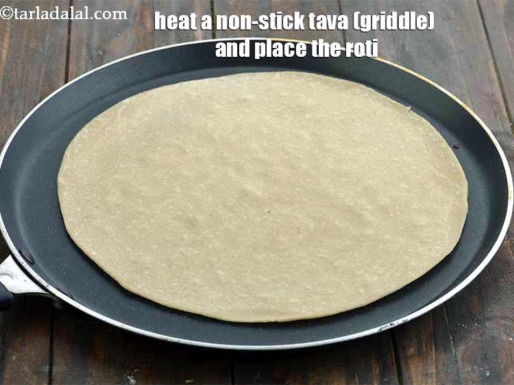 Step 10 – <p><span style="background-color:rgb(255,255,255);color:rgb(0,0,0);">To cook the roti, heat a non-stick tava (griddle) and place the roti.</span></p>