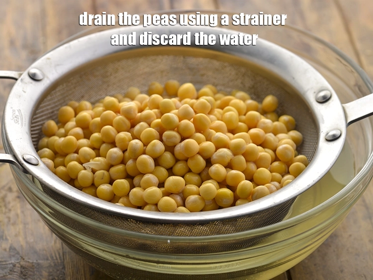 Step 6 – <p>For preparing the ragda, drain the peas using a strainer and discard the water.</p>