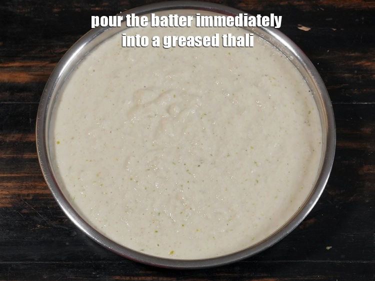 Step 18 – <p>Pour the&nbsp;semolina dhokla&nbsp;batter immediately into a 175 mm. (7”) diameter greased thali and shake the …