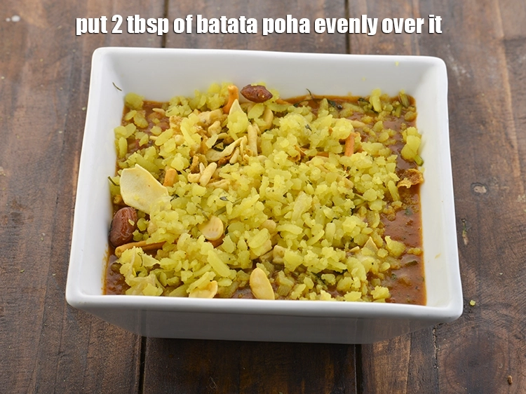 Step 32 – <p>Put 2 tbsp of batata poha evenly over it. This is optional but it does …