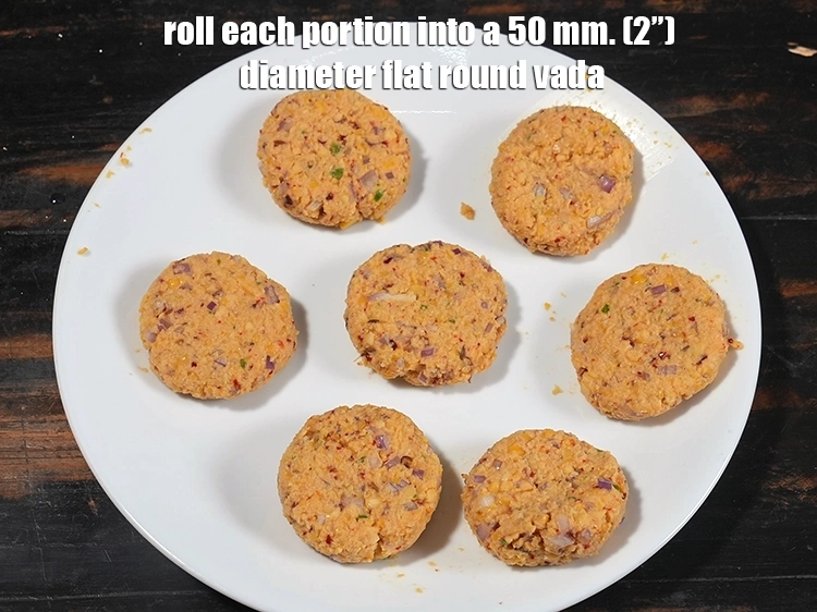 Step 16 – <p><span style="background-color:rgb(255,255,255);color:rgb(0,0,0);">Roll each portion into a 50 mm. (2”) diameter flat round vada.</span></p>