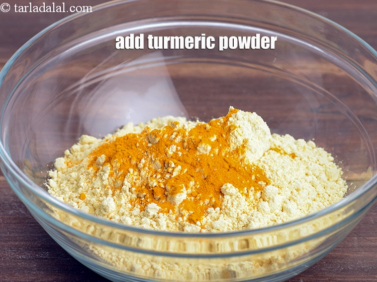 Step 10 – <p><span style="background-color:rgb(255,255,255);color:rgb(0,0,0);">Add turmeric powder. This provides a yellow hue to the fried vada covering.</span></p>