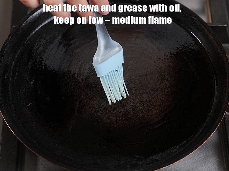 Step 26 – <p><span style="background-color:rgb(255,255,255);color:rgb(34,34,34);">Heat the tawa and grease with oil, keep on low – medium flame.</span></p>